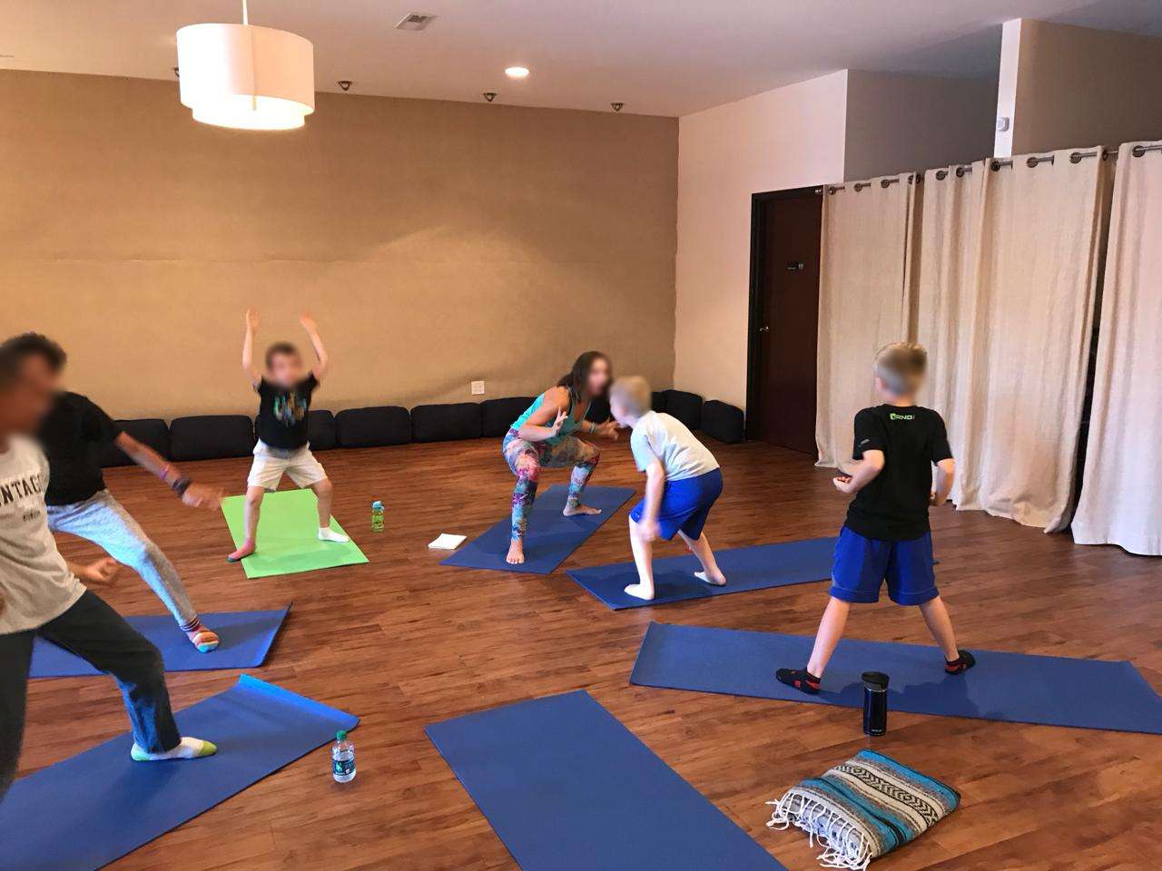Kara crouching with a group of boys at camp — real connection, real fun
