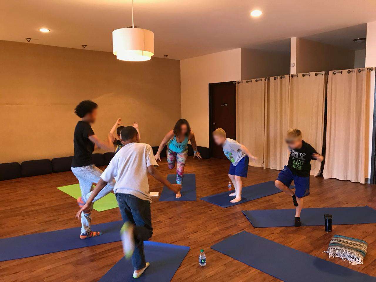 Kara and campers mid-jump in the Zin Yoga Studio — pure energy, every afternoon